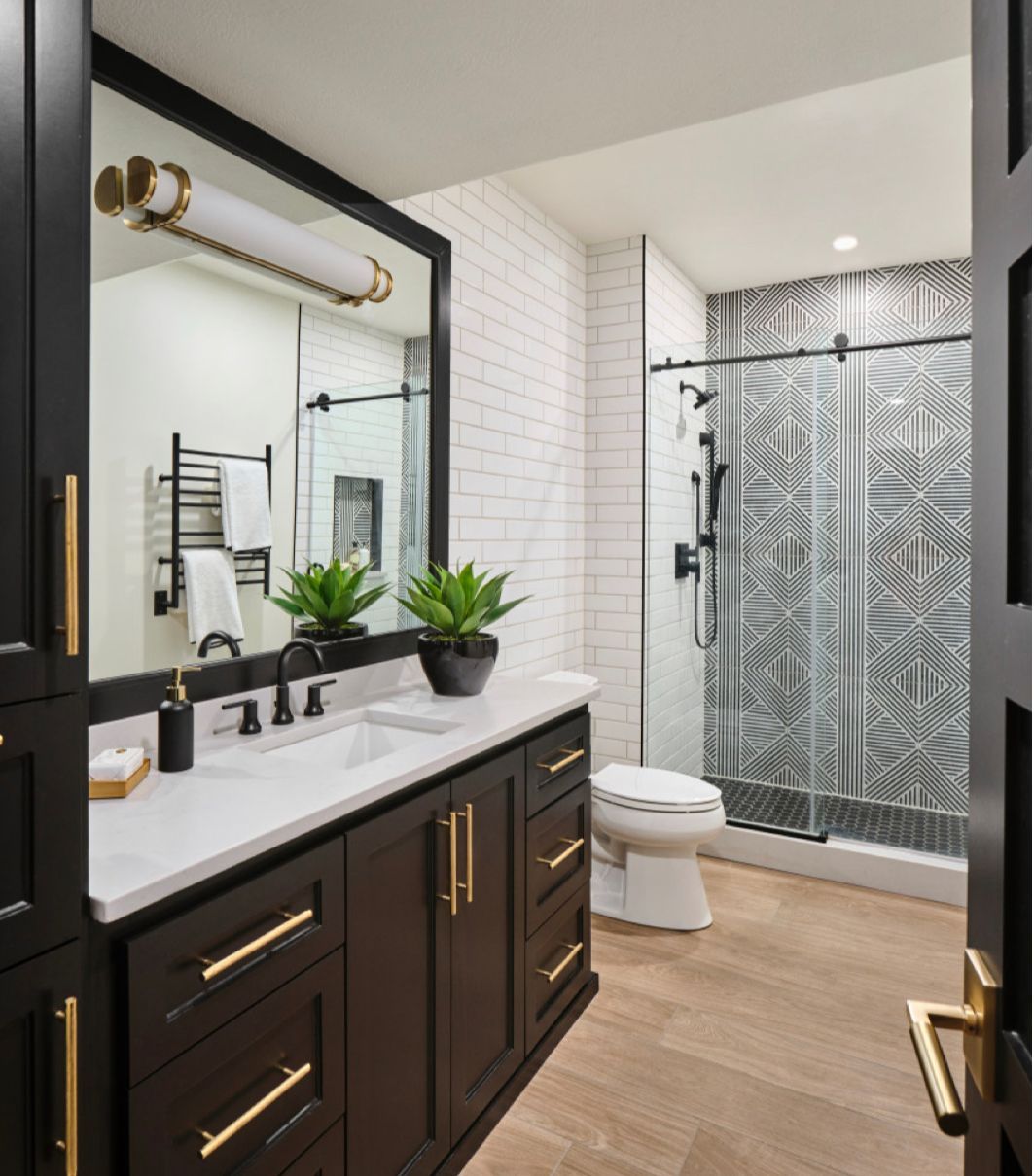 A bathroom with a toilet a sink and a mirror