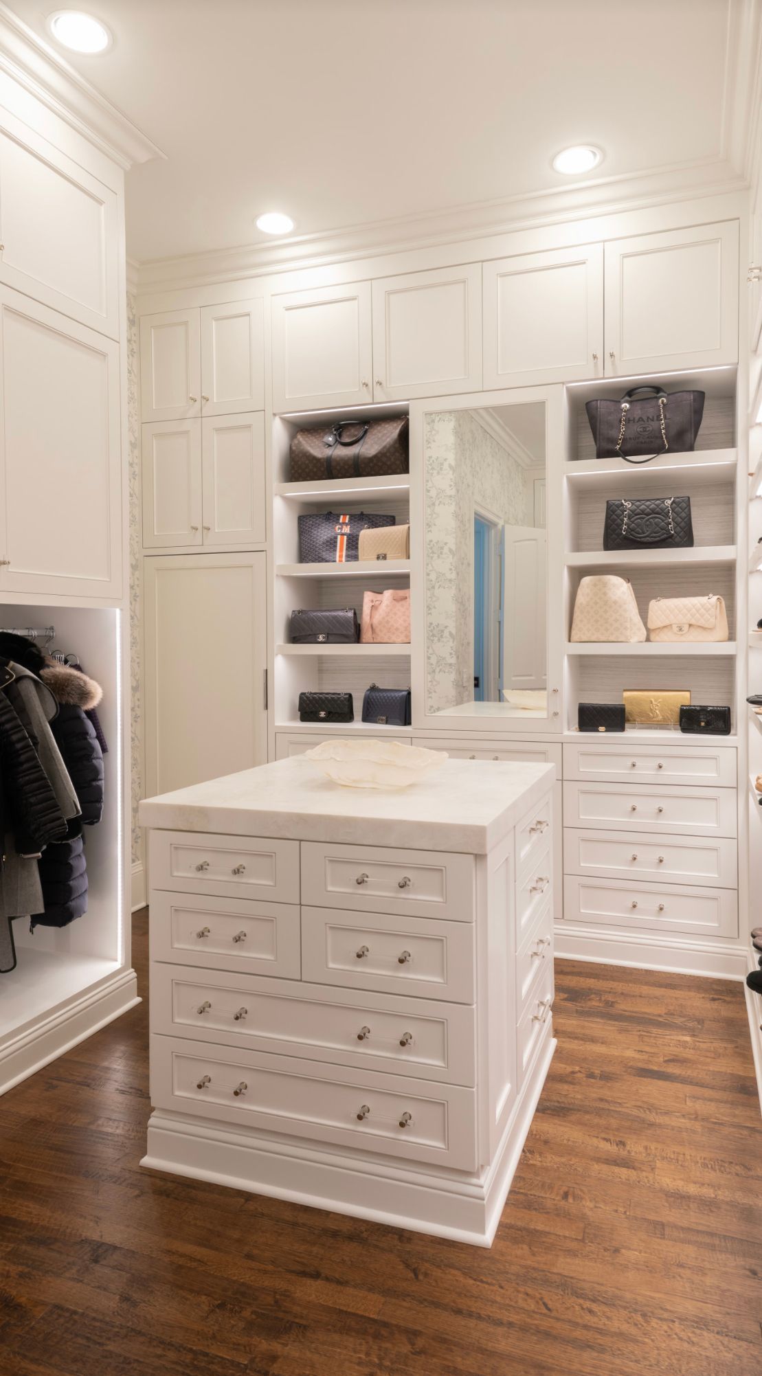 There is a large island in the middle of the closet.