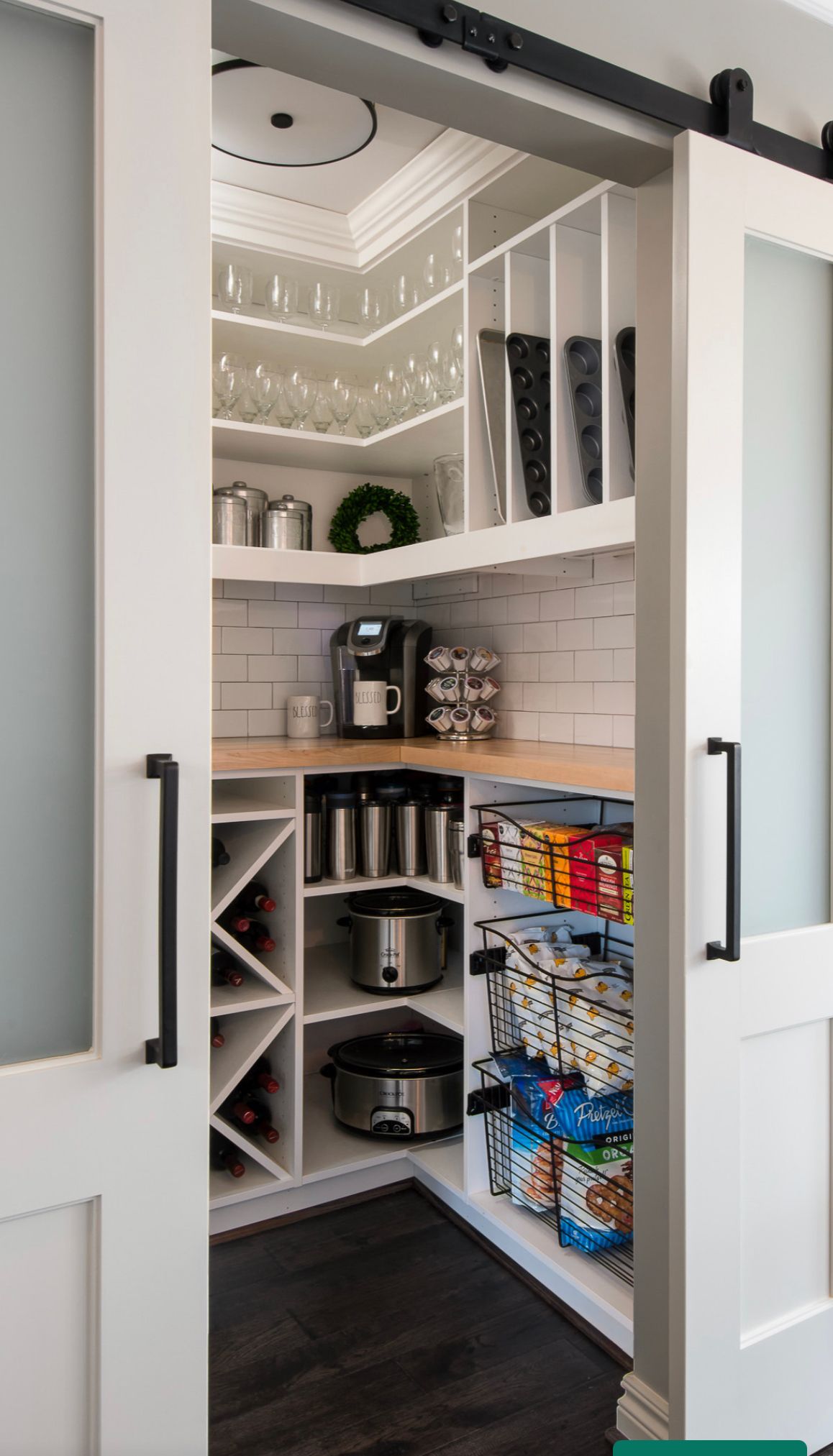 A pantry with sliding barn doors and a wine rack.