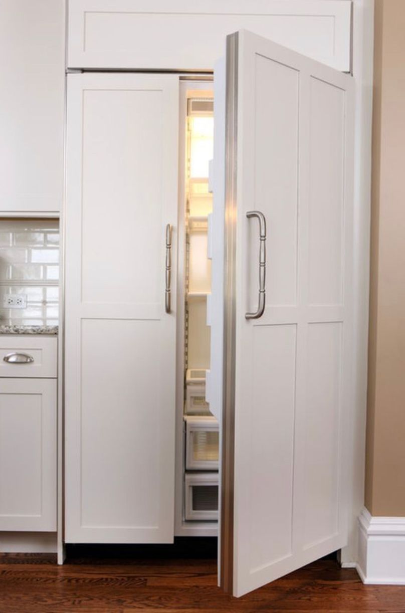 A refrigerator in a kitchen with the door open