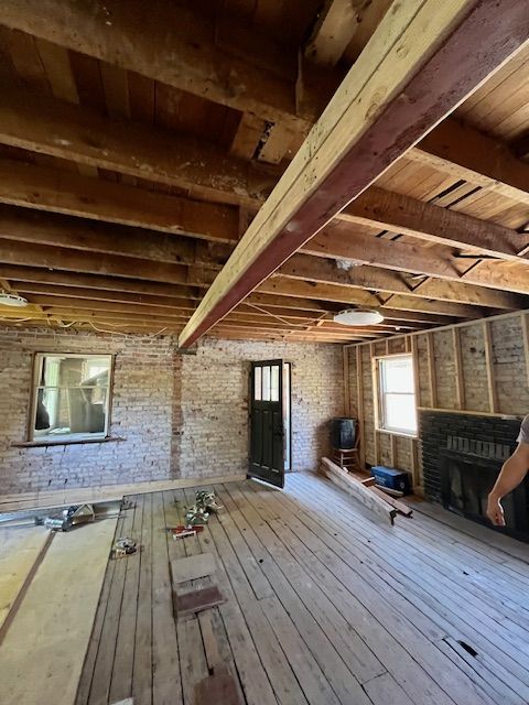 A man is measuring a wall with a level.