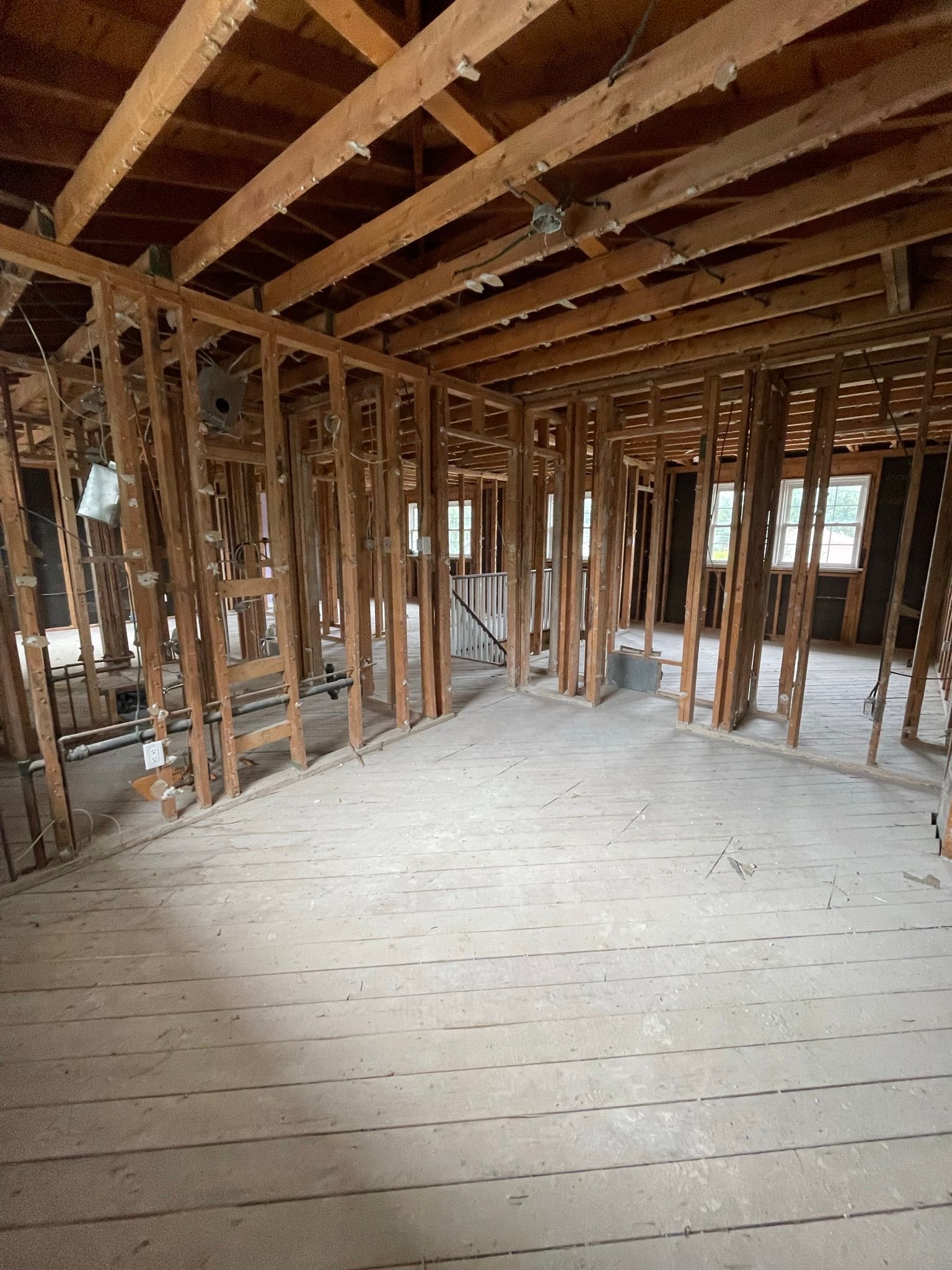 A large empty room with a lot of wooden beams.