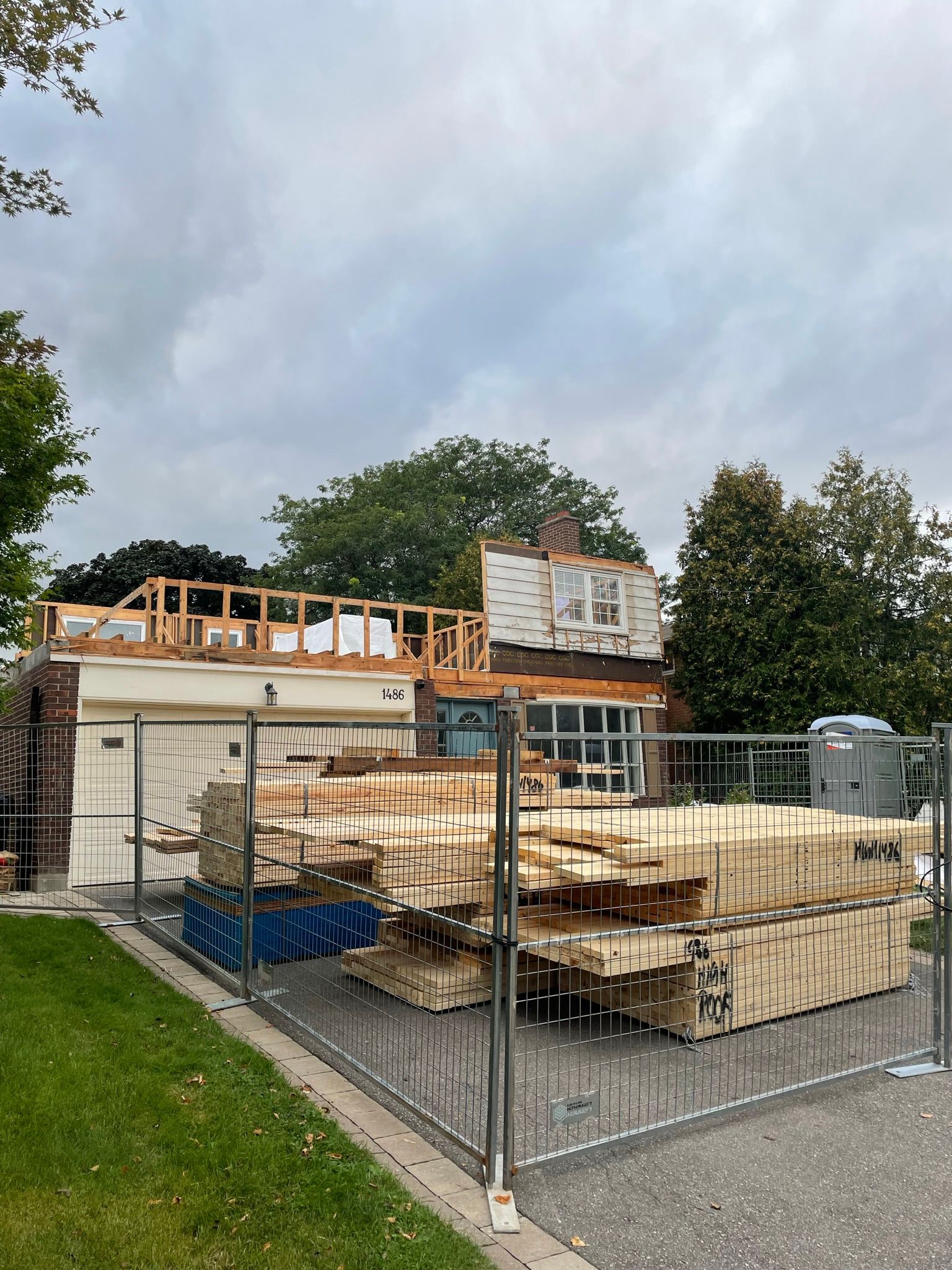 A house under construction with a fence around it.