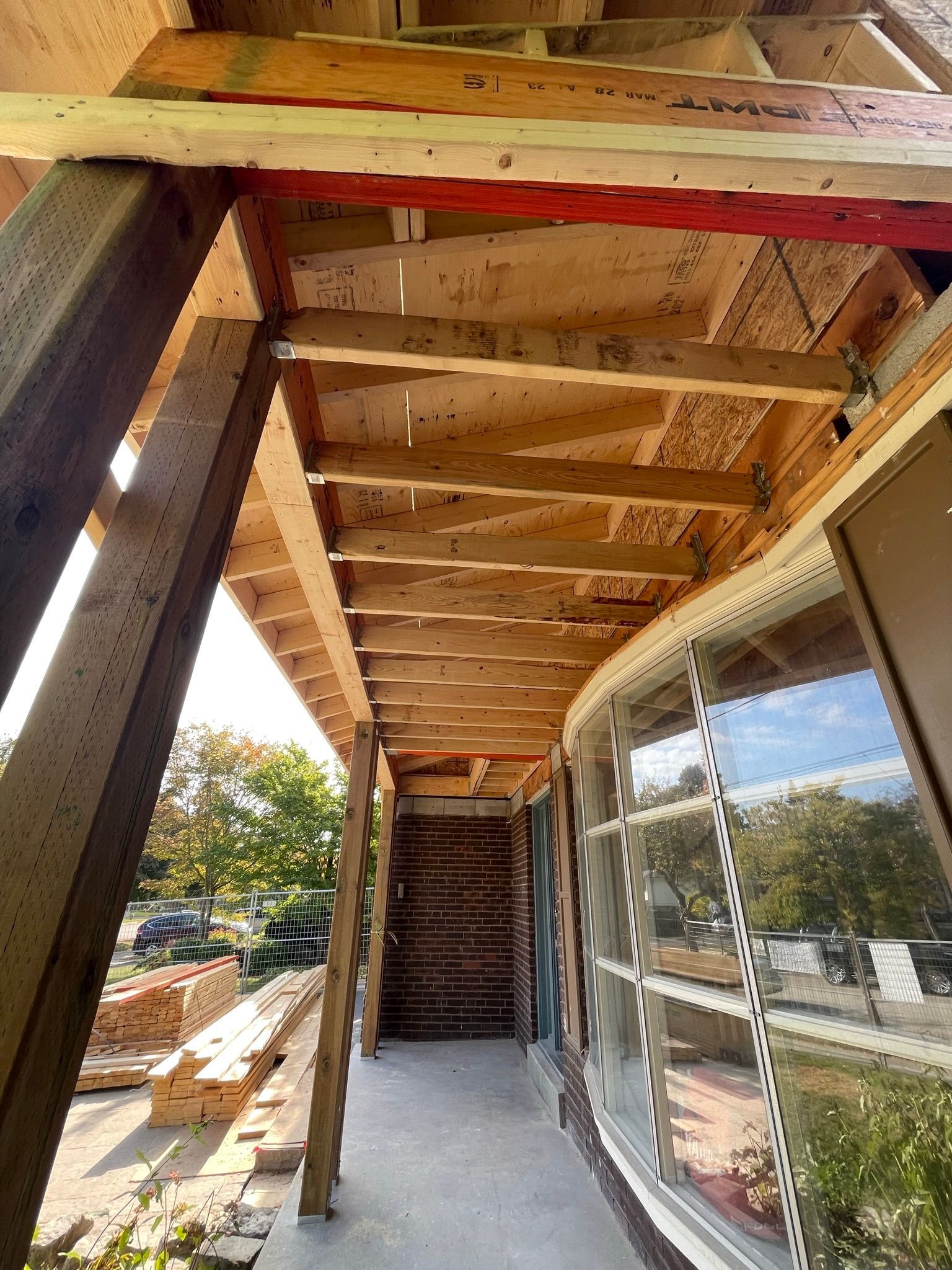 A long wooden walkway leading to a building under construction.