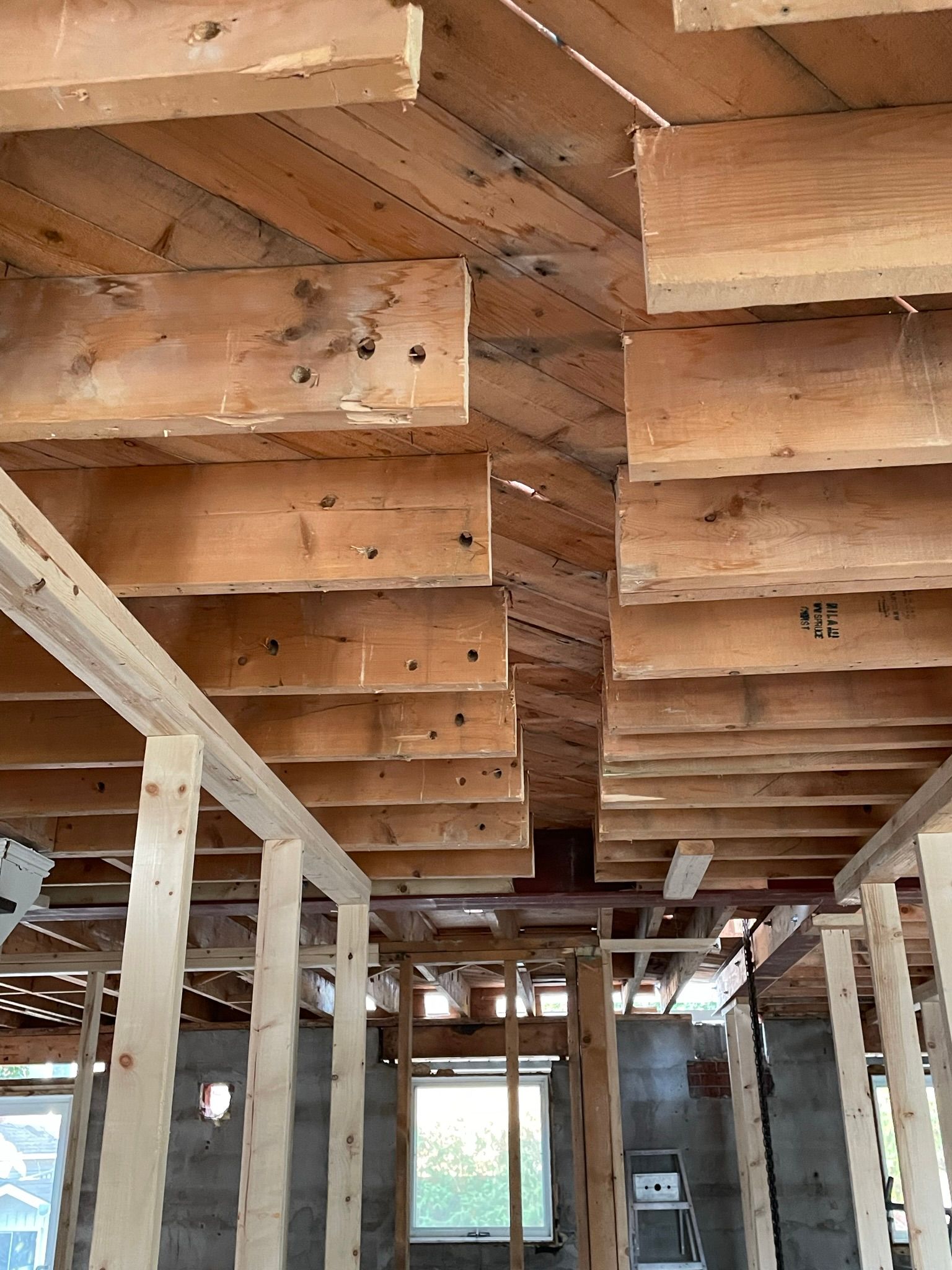 A room with a lot of wooden beams hanging from the ceiling.