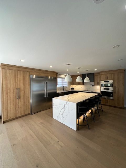 A kitchen with a large island in the middle of it