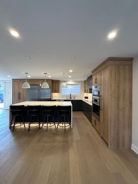 A kitchen with wooden cabinets and stainless steel appliances