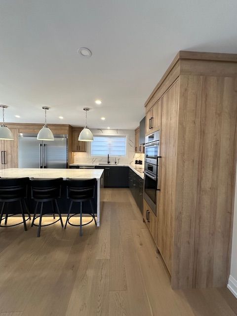 A kitchen with wooden cabinets and stainless steel appliances