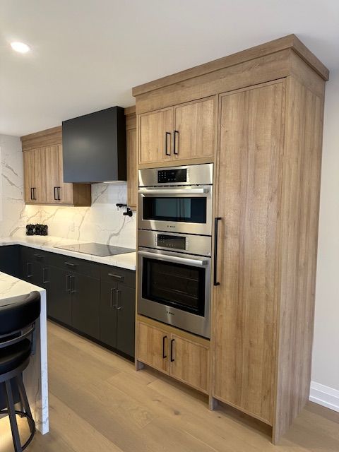 A kitchen with stainless steel appliances and wooden cabinets