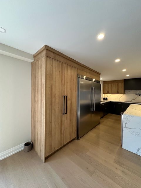 A kitchen with stainless steel appliances and wooden cabinets