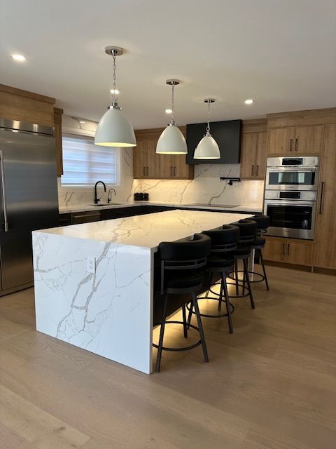 A kitchen with a large island and stools