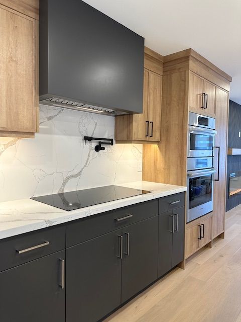 A kitchen with a stove top oven and wooden cabinets