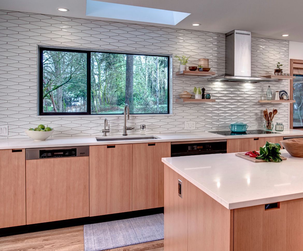 A kitchen with wooden cabinets and a white counter top