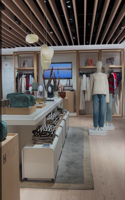 A person is measuring a wall with a tape measure.