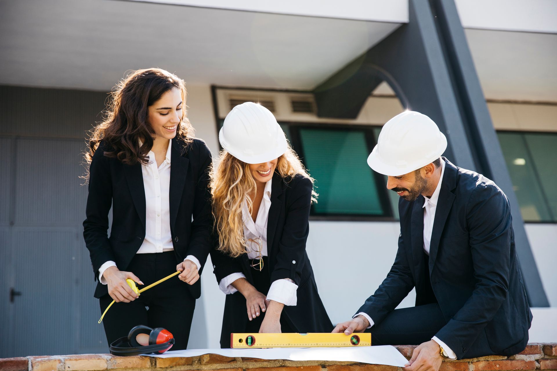 A group of construction workers are looking at a blueprint.