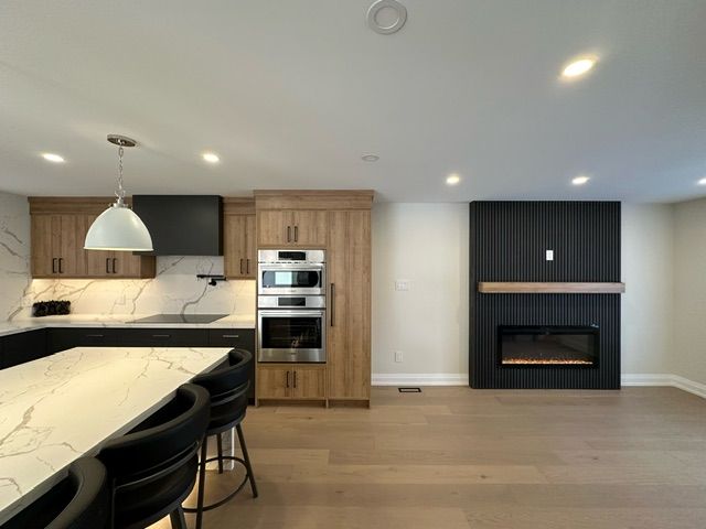 A kitchen with a table and chairs and a fireplace