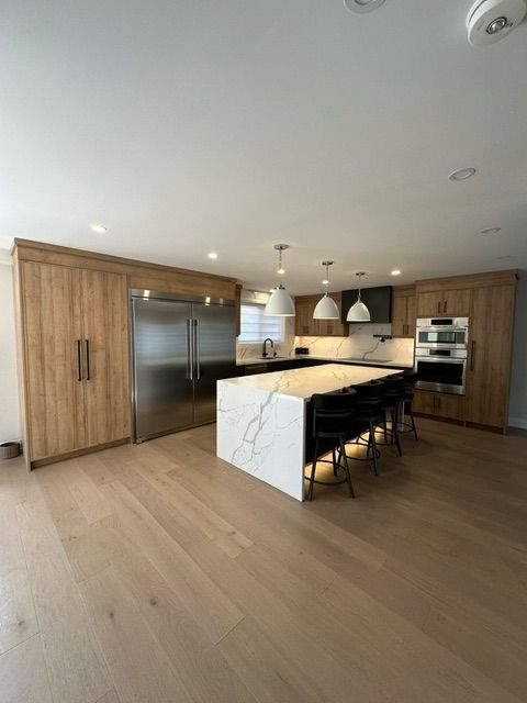 There is a large island in the middle of the kitchen.