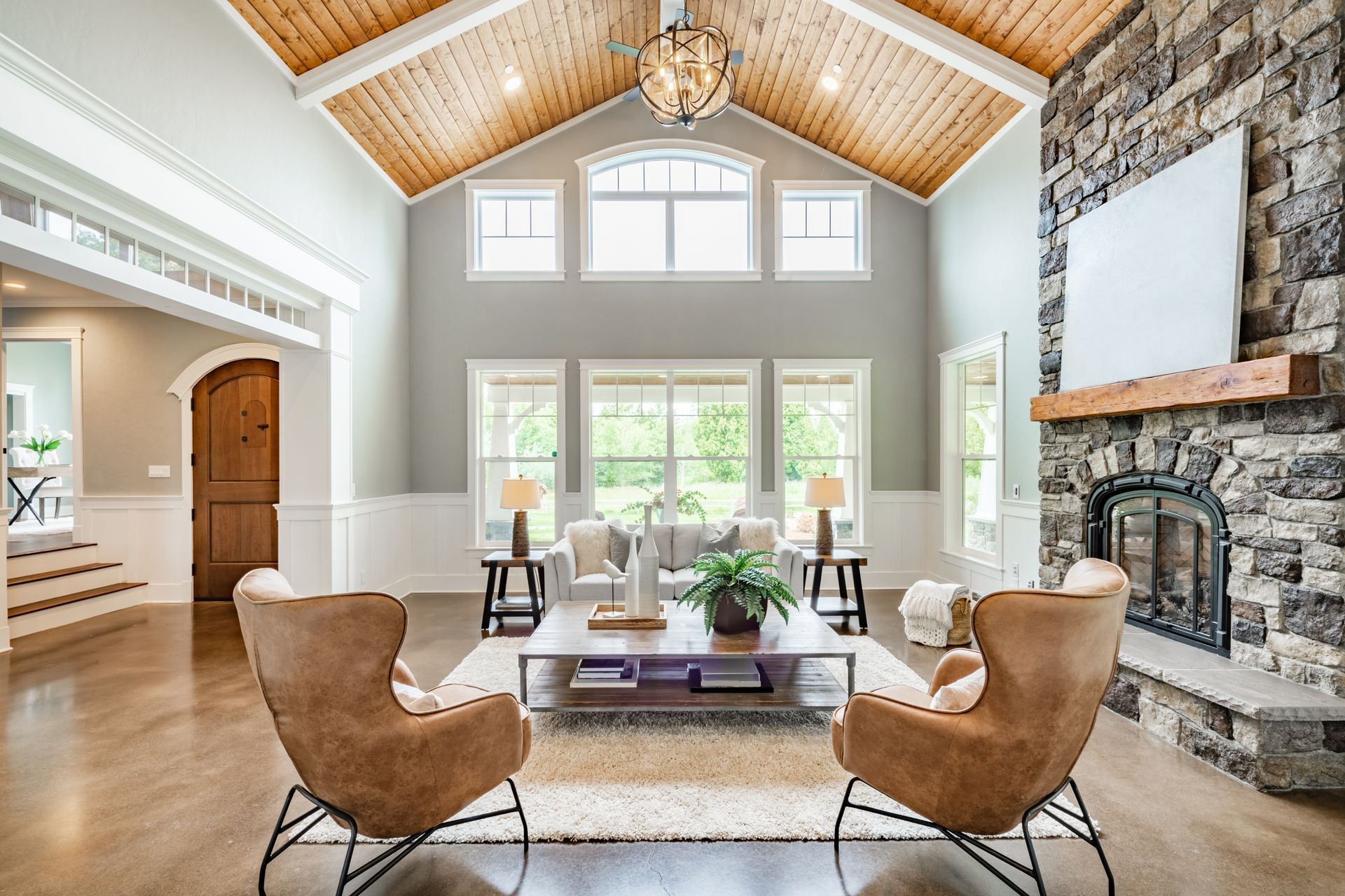 A living room with a vaulted ceiling and a fireplace.