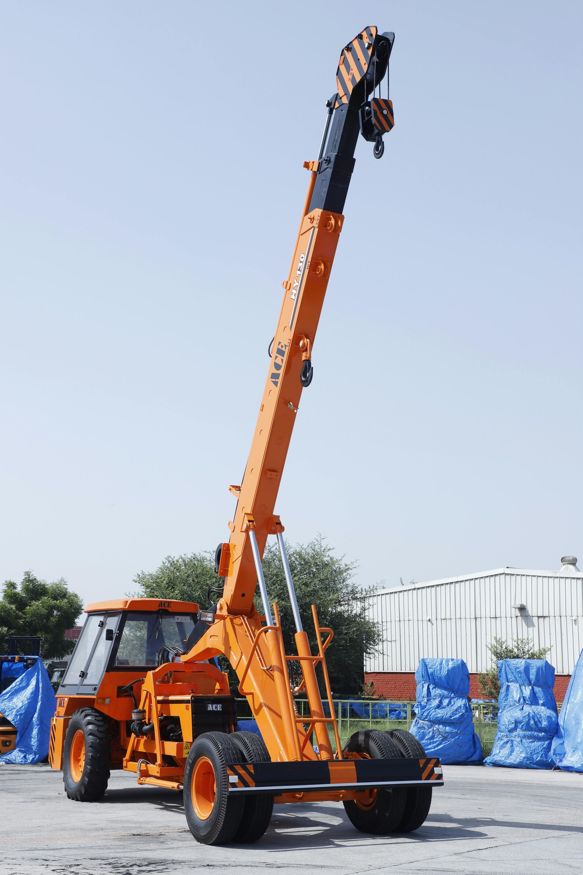 Yellow construction crane against a clear blue sky