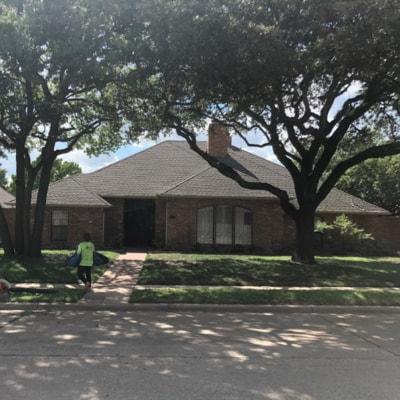 A brick house with a tree in front of it