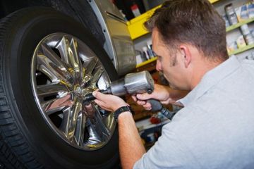 Mechanic Putting Tire on a Car - Auto Repair Shop in Fredericksburg, VA