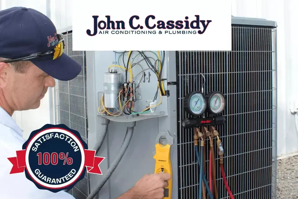 HVAC technician working on an air conditioner with gauges. 