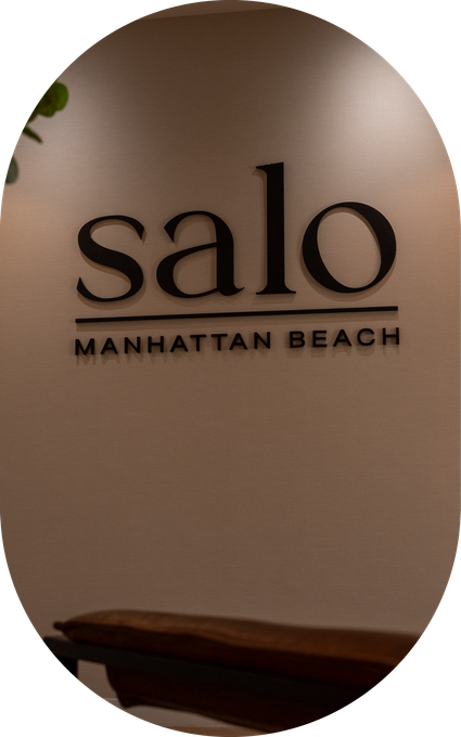 A sign on a wall that says salo manhattan beach