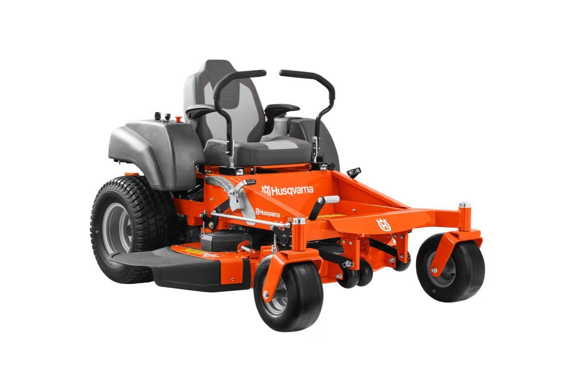 Orange Husqvarna zero-turn lawnmower with black seat, shown on white background.