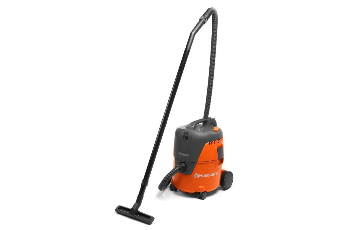 Orange and black Husqvarna wet/dry vacuum with a black hose and wand, on a white background.
