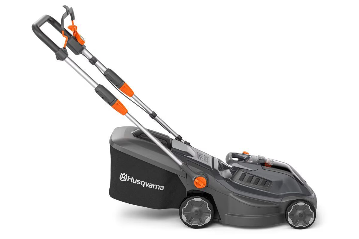 Husqvarna electric lawn mower, black and gray with orange accents, grass catcher attached.