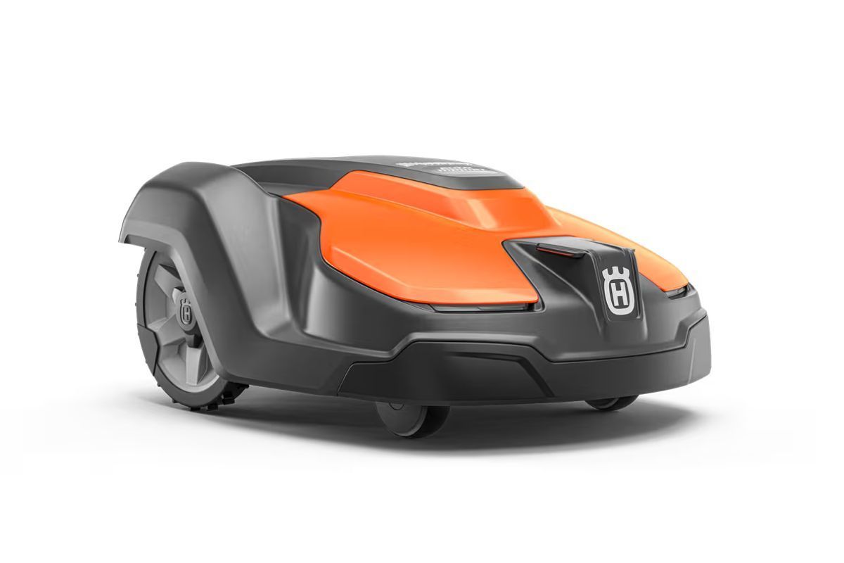 Orange and black Husqvarna robotic lawn mower on a white background.