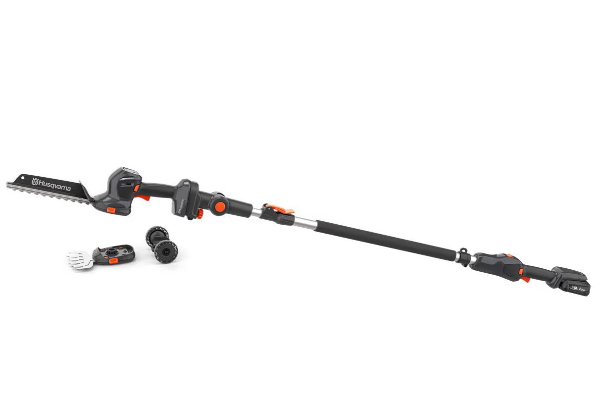 Black and orange telescoping pole hedge trimmer with a detached saw and connector.