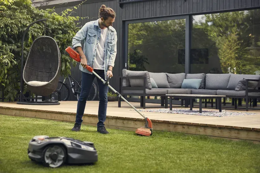 A Woman is Riding a Lawn Mower on a Lush Green Lawn — Tuggerah Outdoor Power in Tuggerah, NSW
