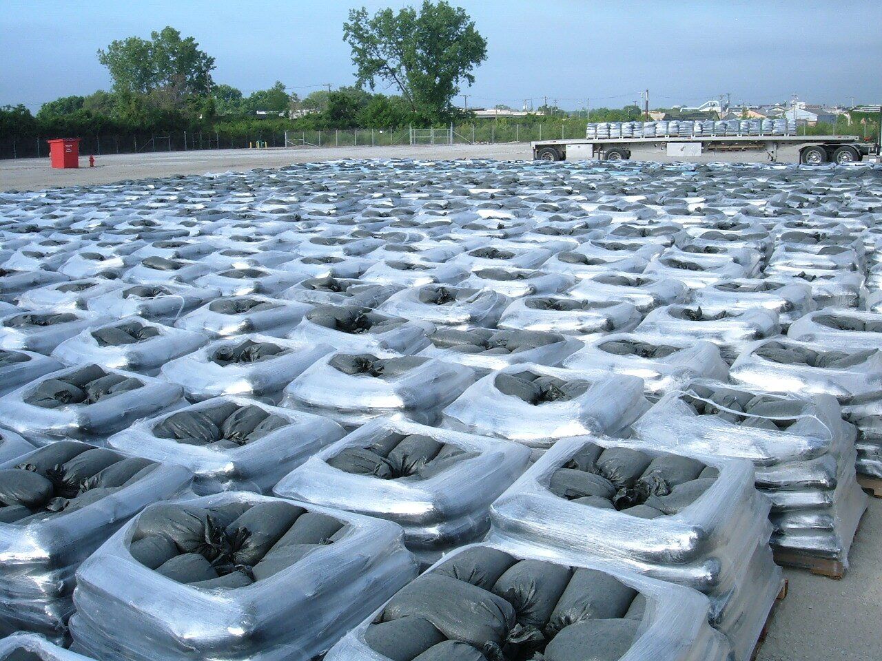Palettes of sandbags are plastic wrapped.
