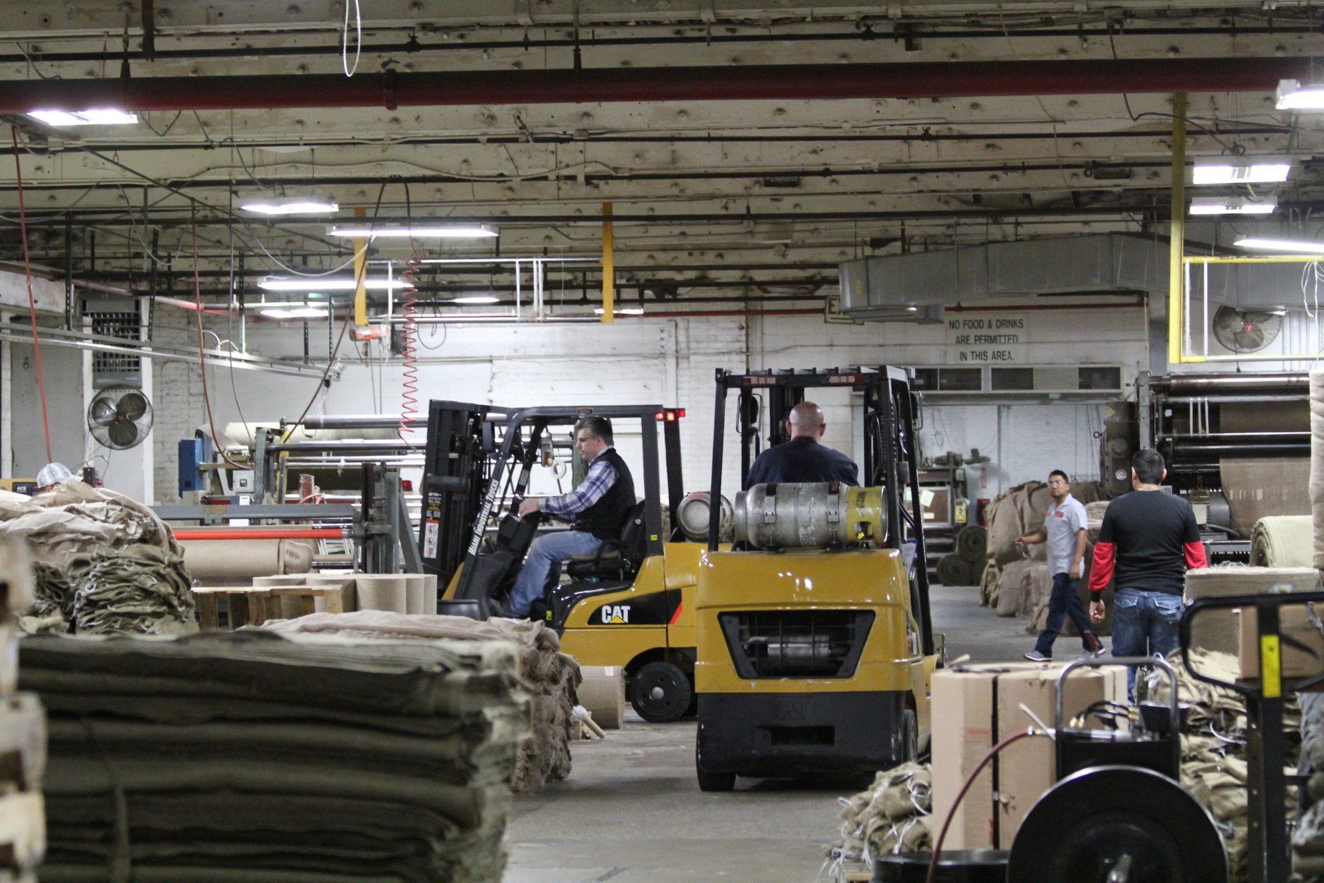 Multiple forklifts in a factory.