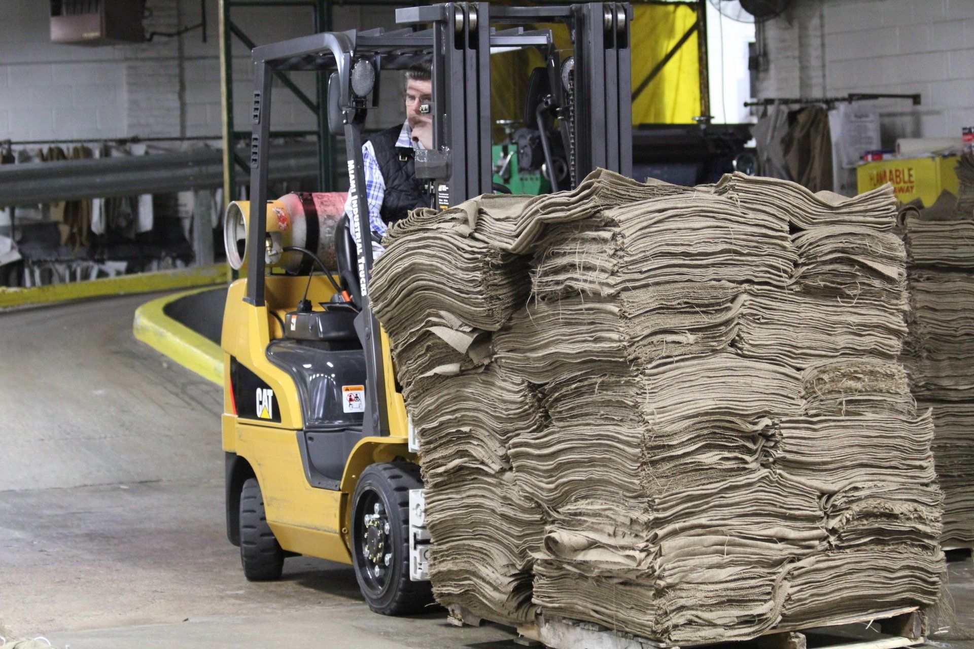 A forklift moving burlap.