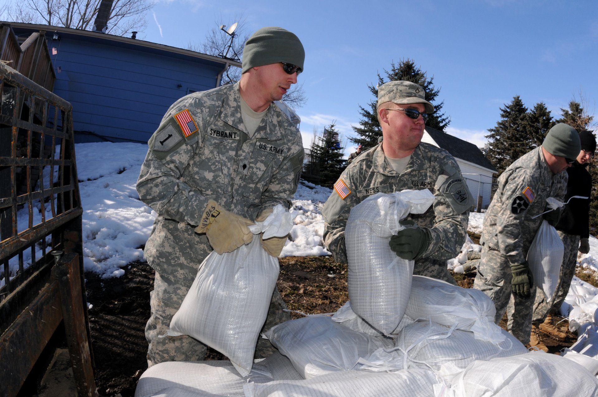 Men moving sandbags.