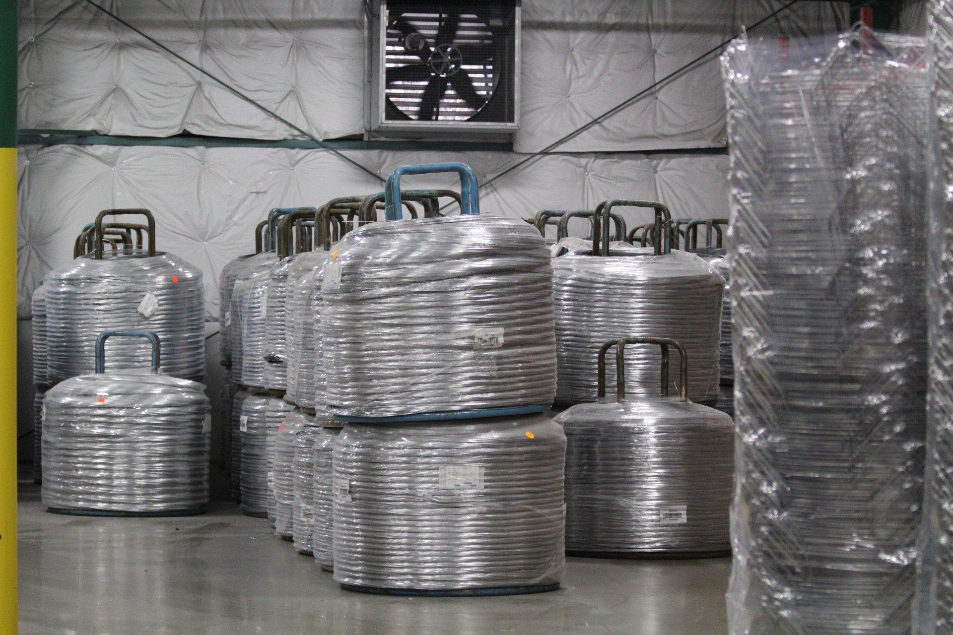 Spools of wire material for baskets.