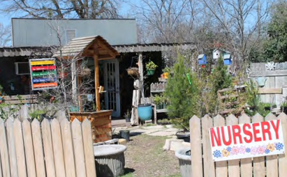 A wooden fence with a sign that says nursery on it