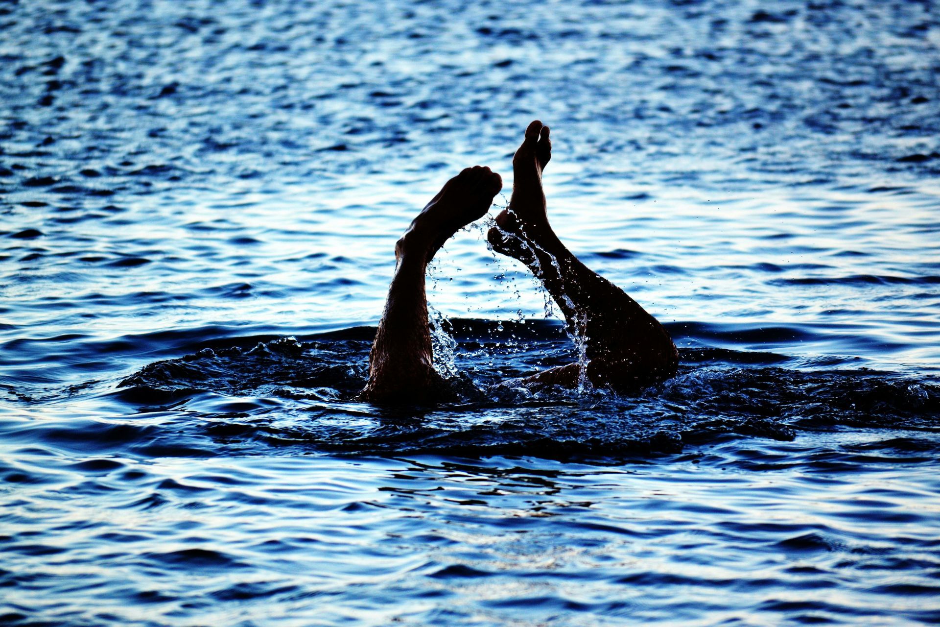 Feet sticking out the water with upper body submerged