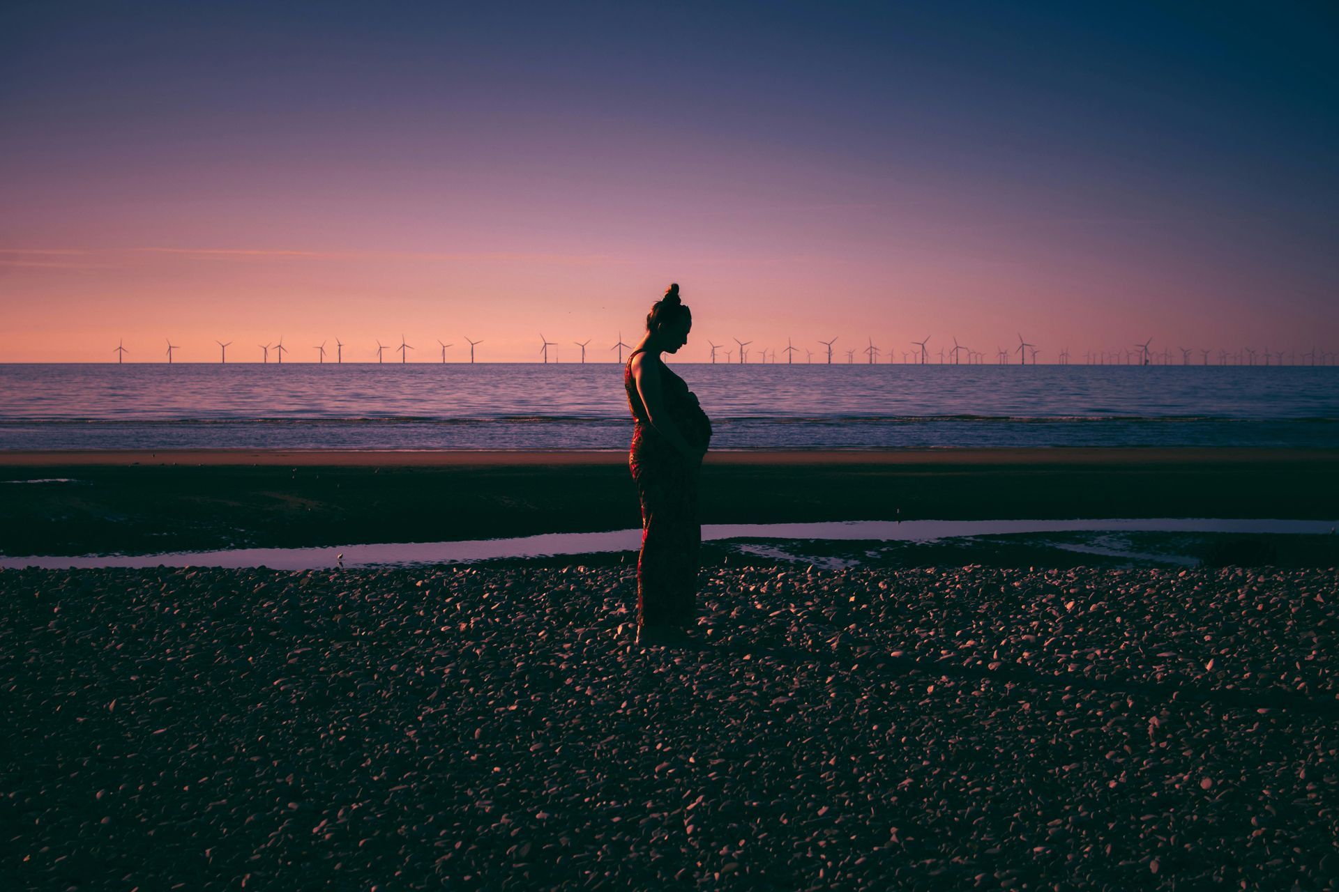 Pregnent woman standing on the beach