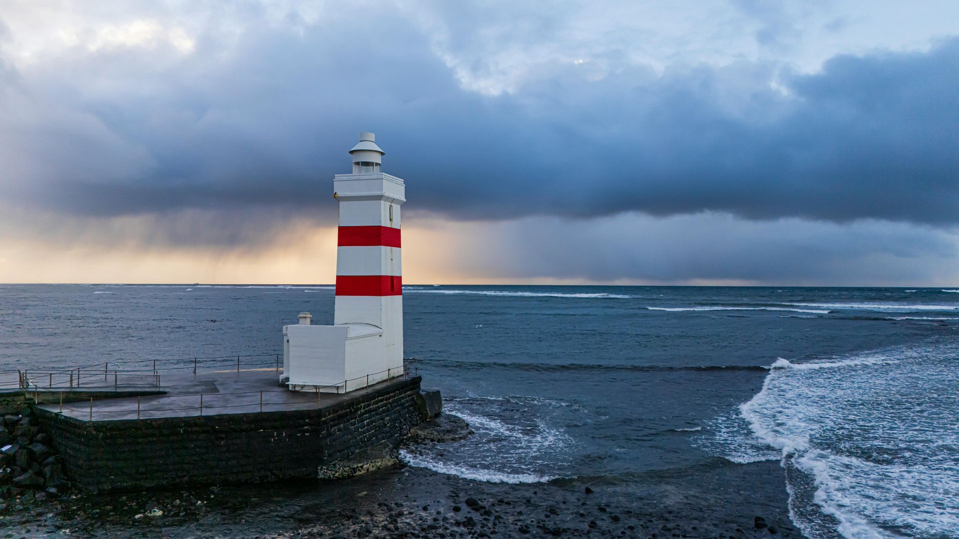 Lighthouse on the edge of and icy cold shore