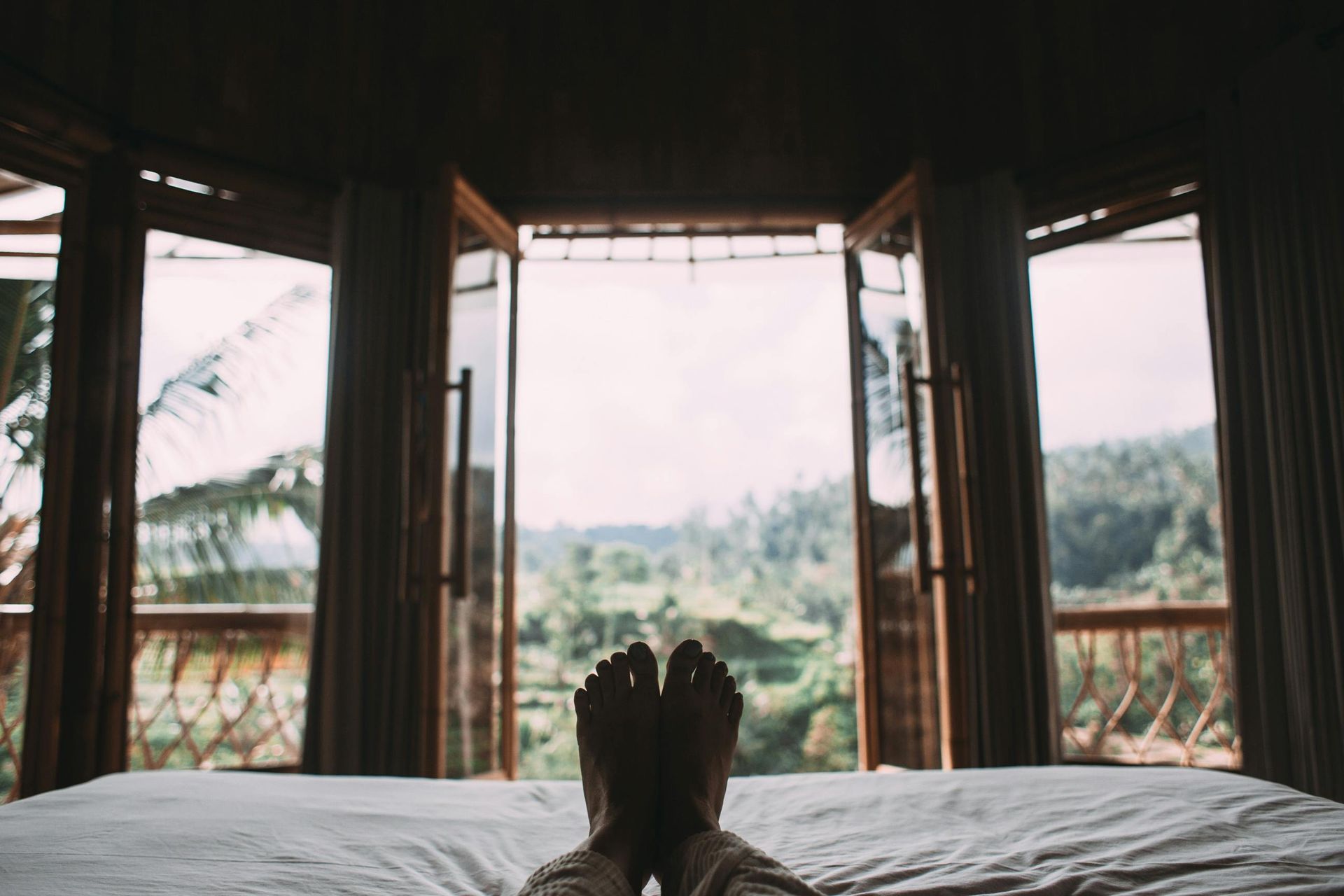 Photo of feet with a back view of the islands in bali