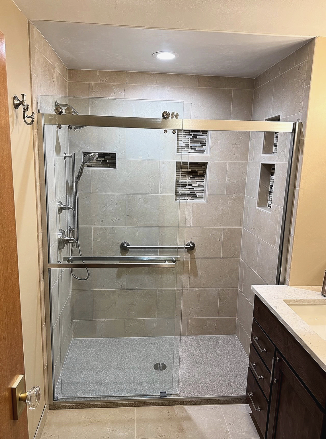 A bathroom with a toilet and a walk in shower