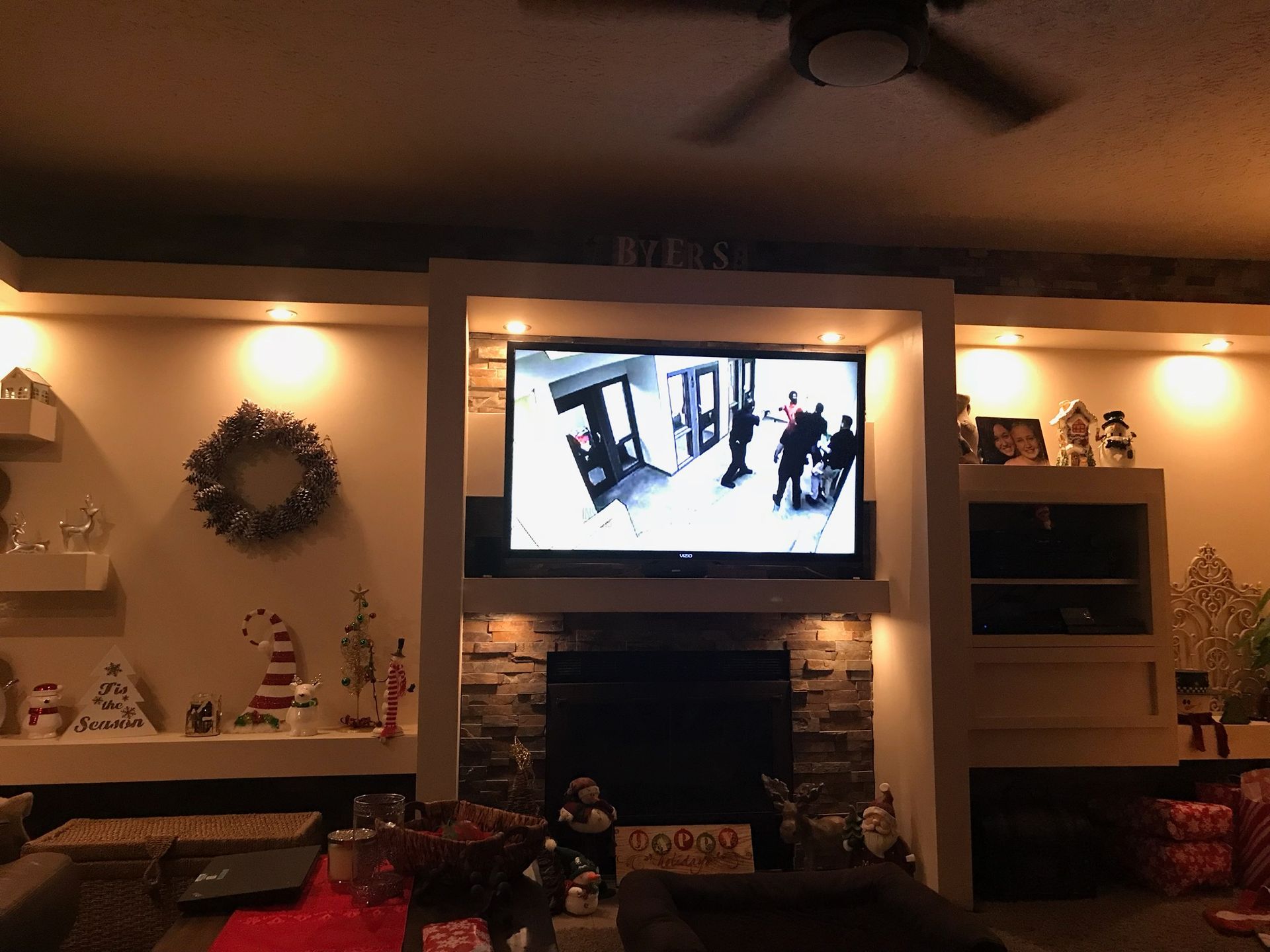 A living room with a fireplace and a flat screen TV.
