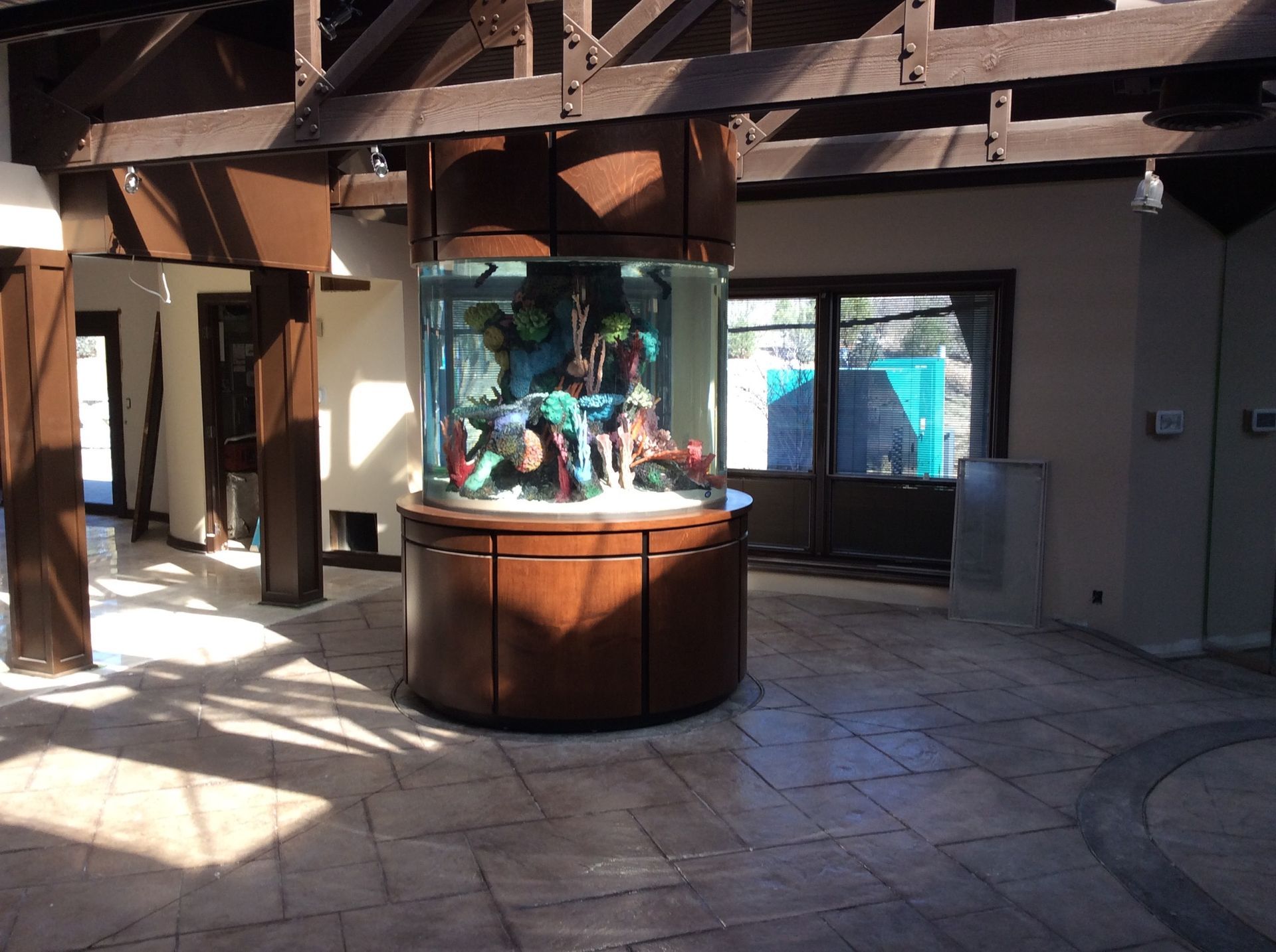 A large aquarium is in the middle of a room.