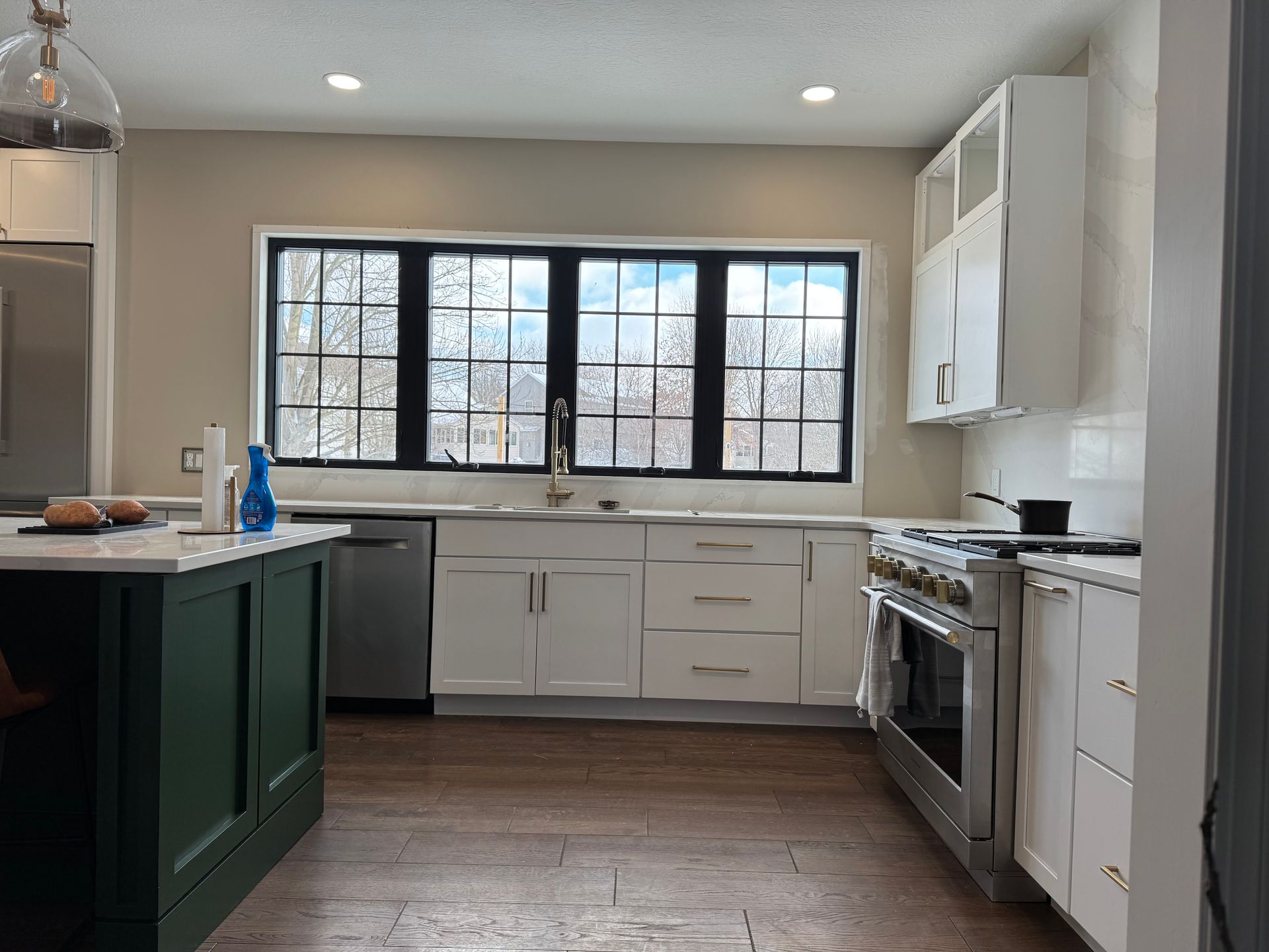 A kitchen with white cabinets and stainless steel appliances