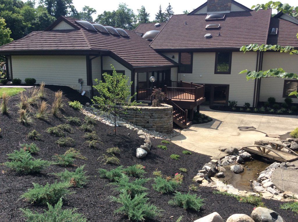 A large white house with a brown roof.