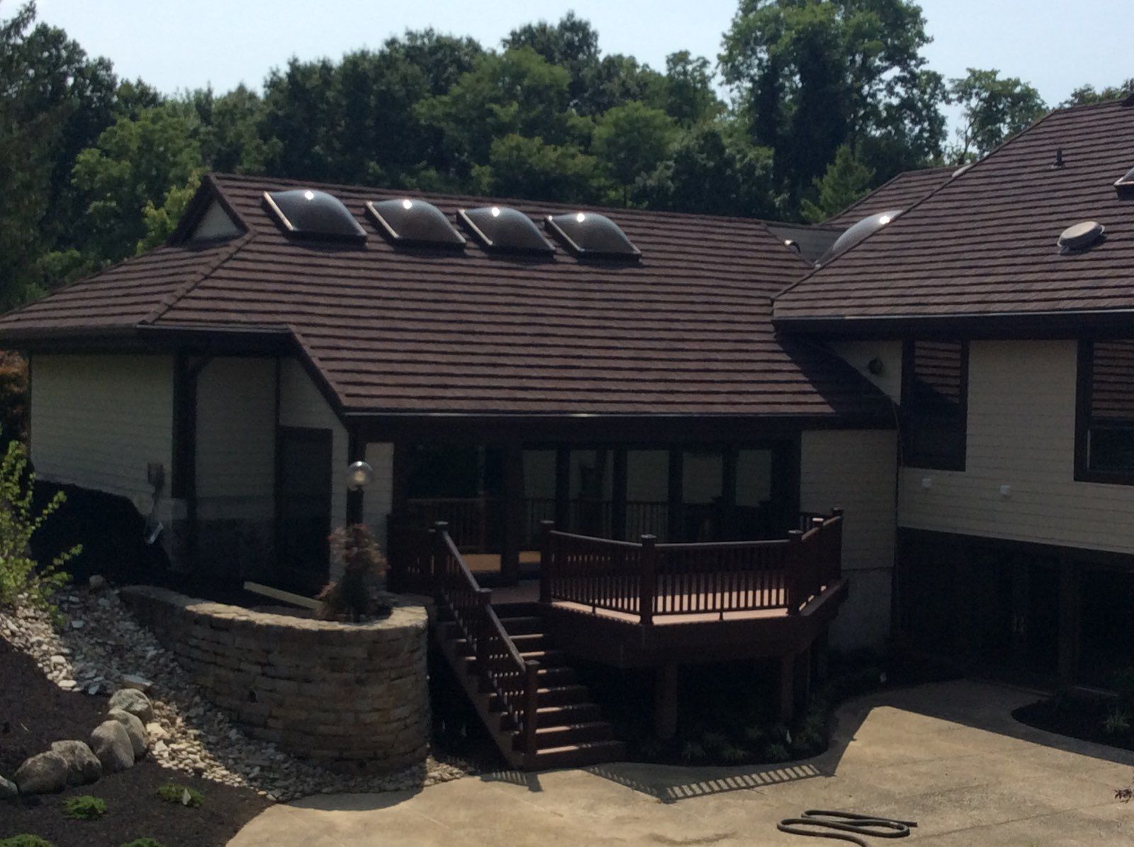 A large house with a large deck and stairs.