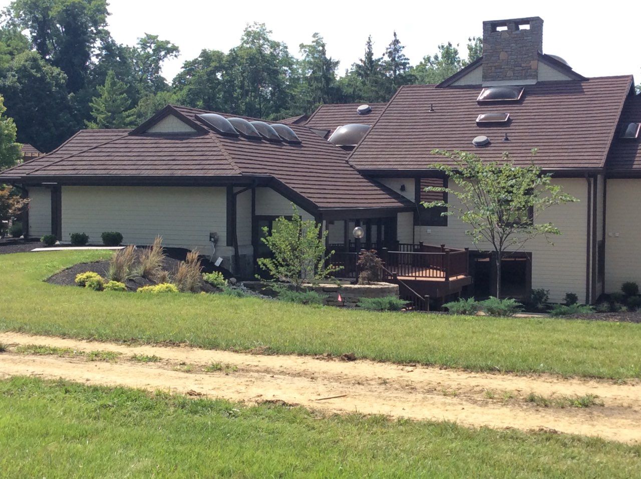 A large house with a dirt road leading to it